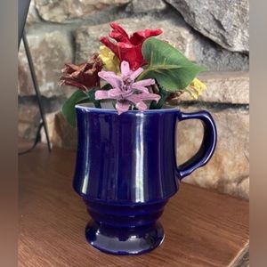 Real pinecones hand cut and painted, arranged in a ceramic cup.